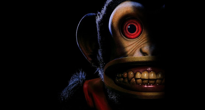 Close up of the monkey's dimly lit face. Perkins, Osgood. The Monkey, 2025.
