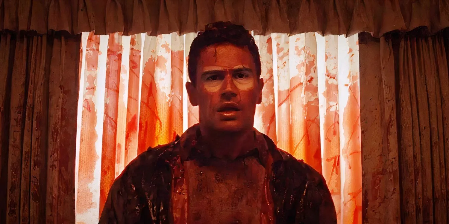 Adult Hal stands facing the camera, soaked in blood. Perkins, Osgood. The Monkey, 2025.