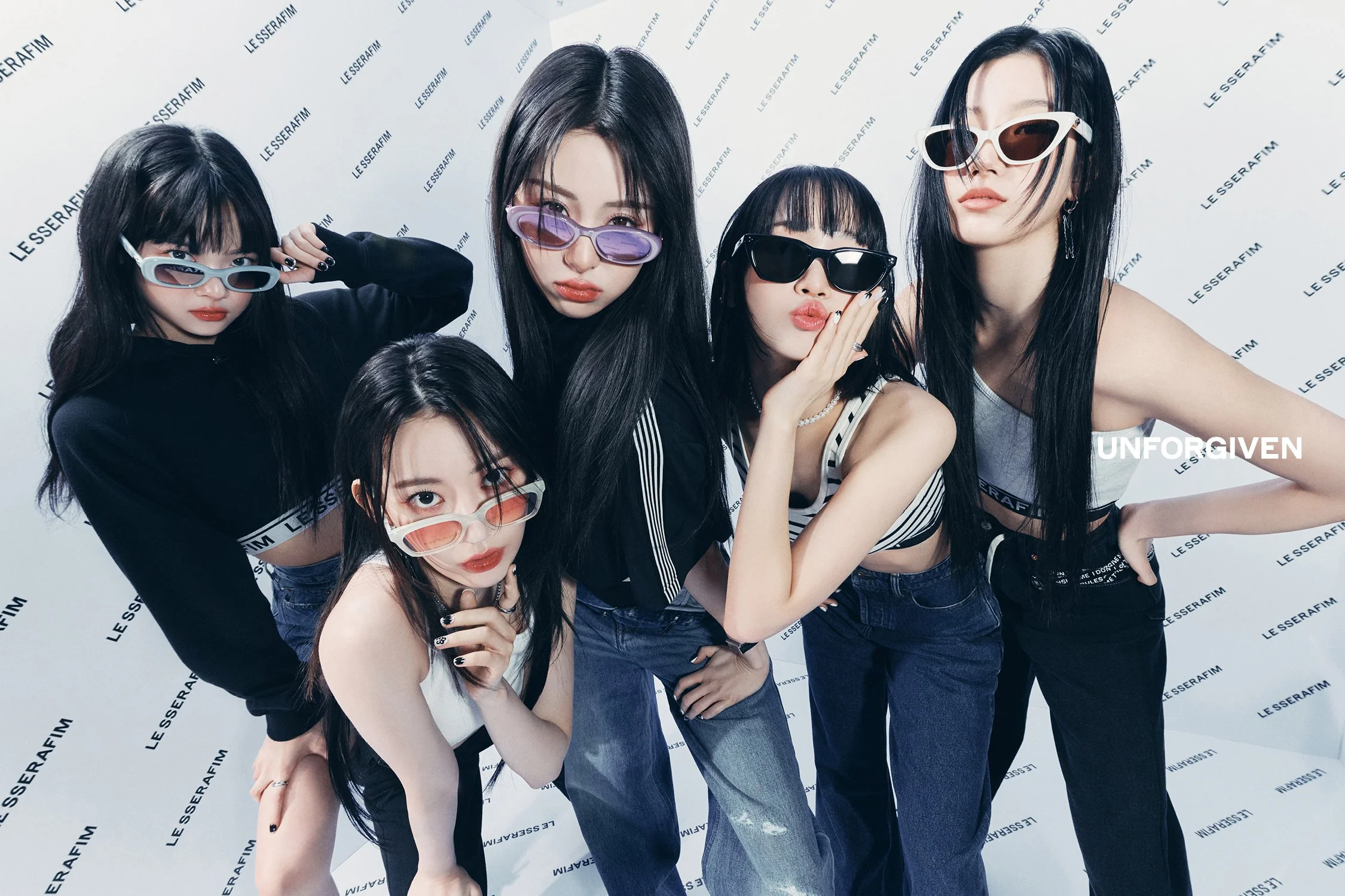 LE SSERAFIM members Eunchae, Sakura, Yunjin, Chaewon, and Kazuha pose using a fish eye lens in a white room. 