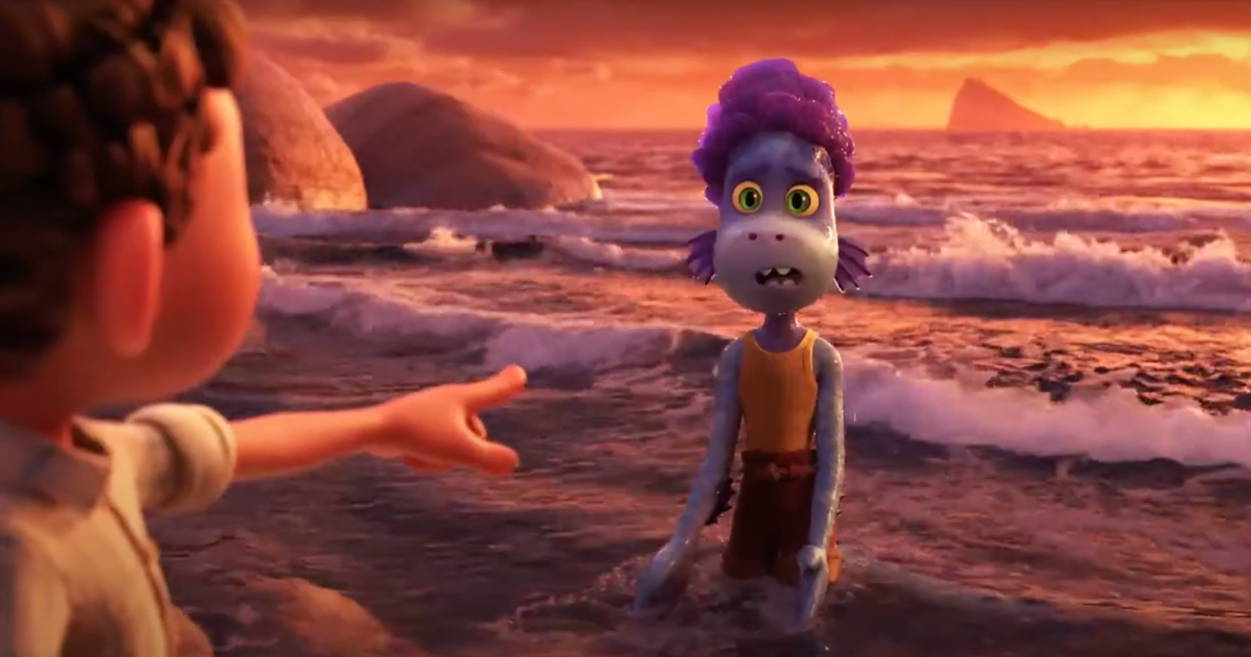 Alberto, shocked and dismayed, stands in the water in sea monster form, as Luca's human form points an accusing finger at him.