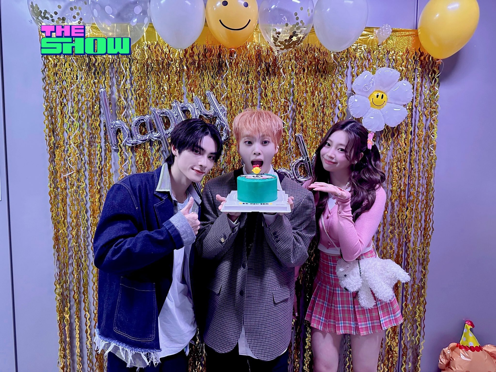 Member Hyeongjun posing with his MC partners, Xiaojun and Nana on his birthday, November 30, 2024 on SBS The Show.