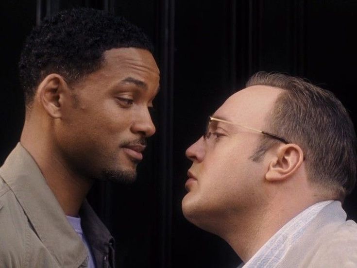 Will Smith and Kevin James intently staring at each other in a still from 'Hitch'