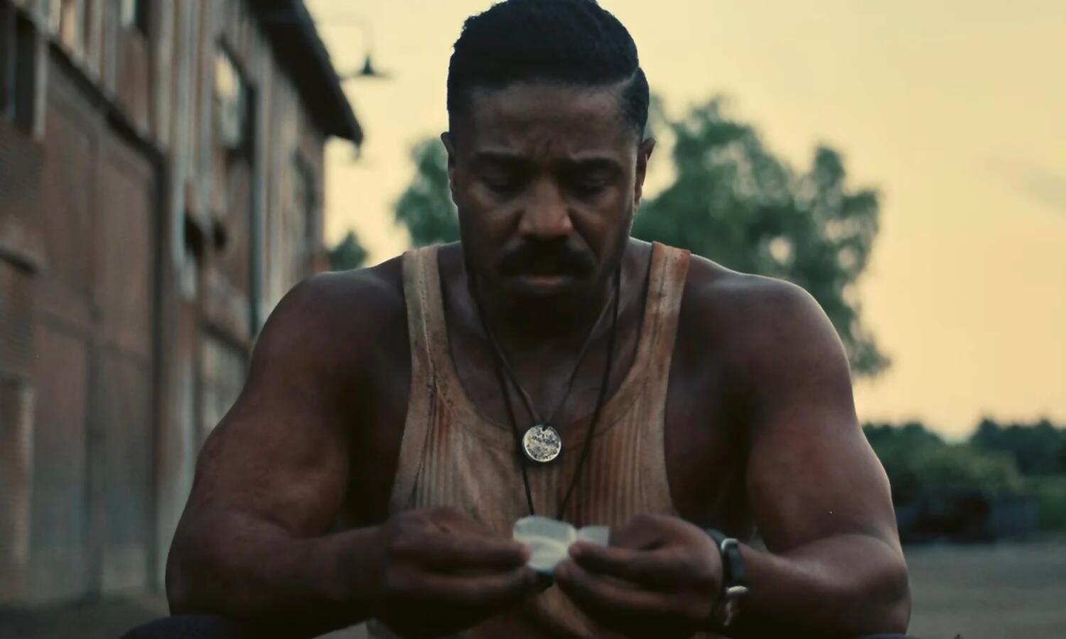 Smoke (Michael B. Jordan) sits, bloody and defeated.
