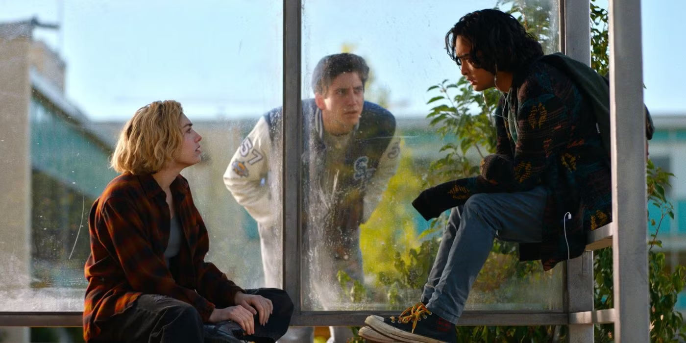 School Spirits characters Maddie and Simon sit as Wally watches from outside.