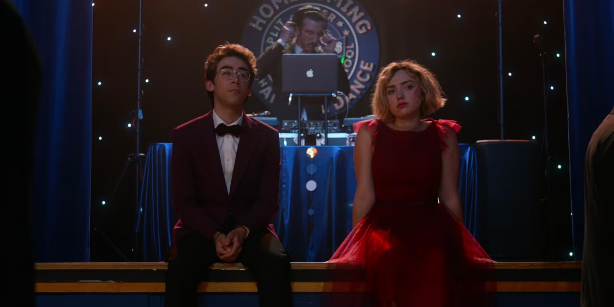 School Spirits characters Charley and Maddie sit together at a high school reunion.