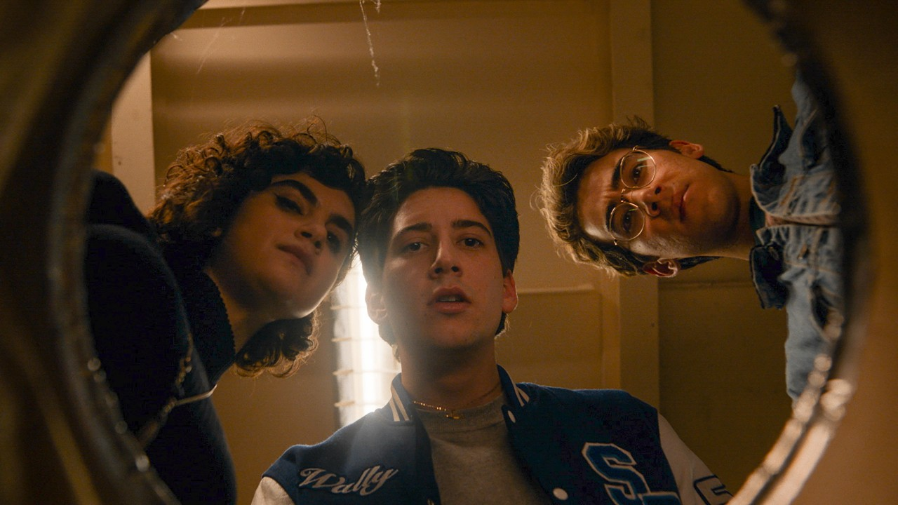 School Spirits characters Rhonda, Wally, and Charley look down at the camera.