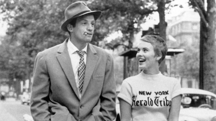 Still from Breathless by Jean-Luc Godard. Michel and Patricia, walking down the city street. 