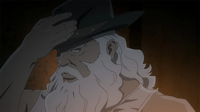 Tobe holds a cowboy hat to his head.