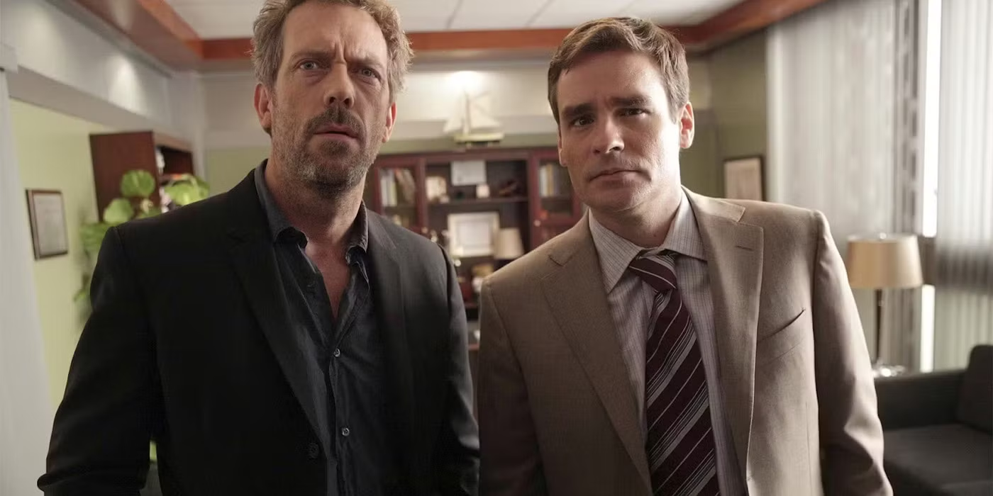 Dr. Gregory House and Dr. James Wilson staring behind the screen. Shore, D. House, 2004–2012.