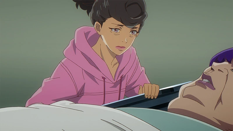 Angela leans over her mothers hospital bed in fear. 