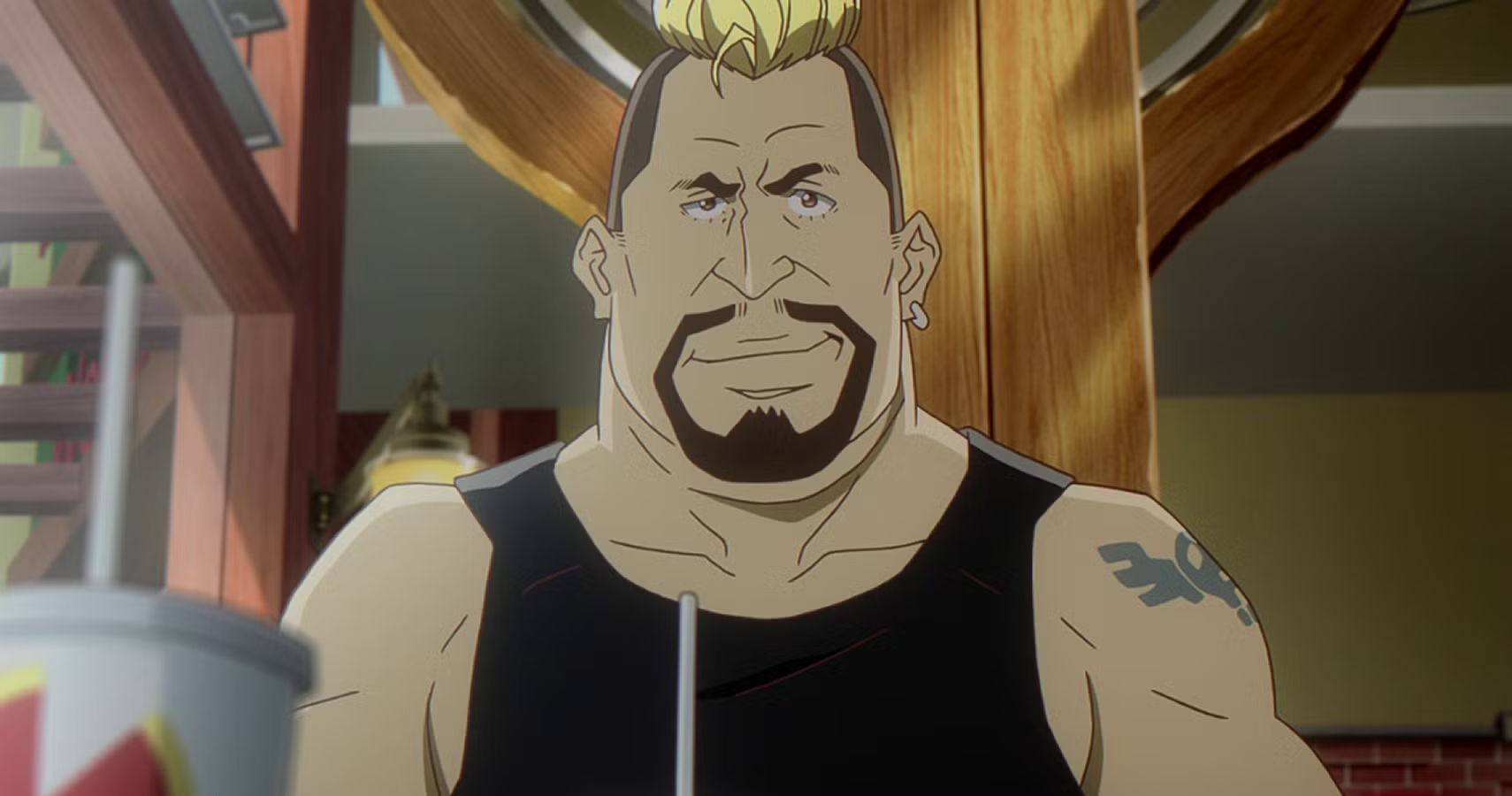 Gus looks towards the screen.