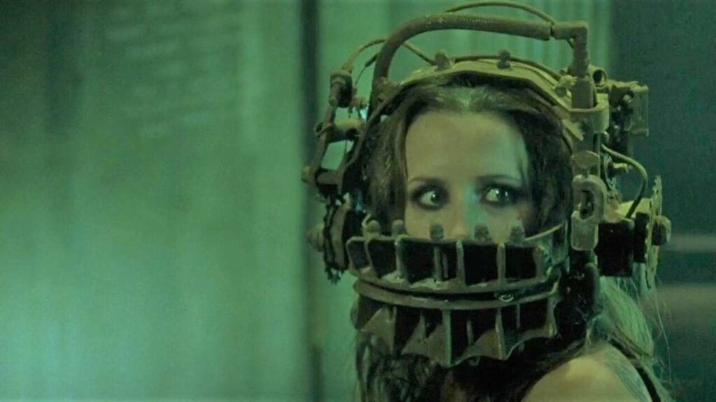 Amanda Young, played by Shawnee Smith, wearing the Reverse Bear Trap on her head. Wan, James, dir. Saw, 2004.