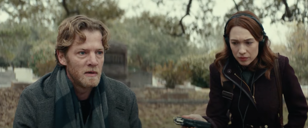 Aaron Korey and Dana Haines, played by Jefferson Hall and Rhian Rees. The two are in a cemetery. 