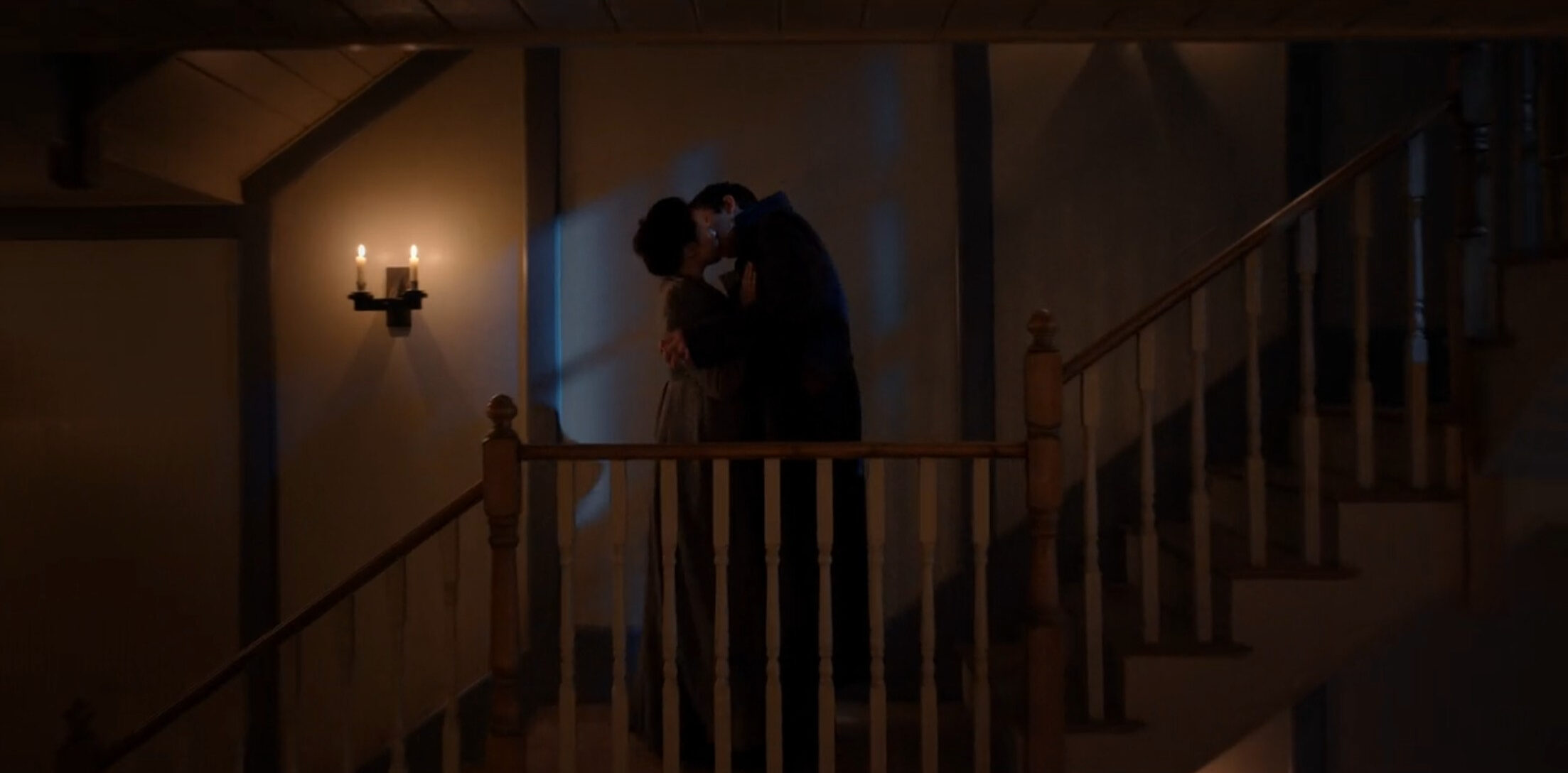 Maid Sophie and Benedict Bridgerton in the servant stairwell of the Bridgerton house. They are embraced and kissing.