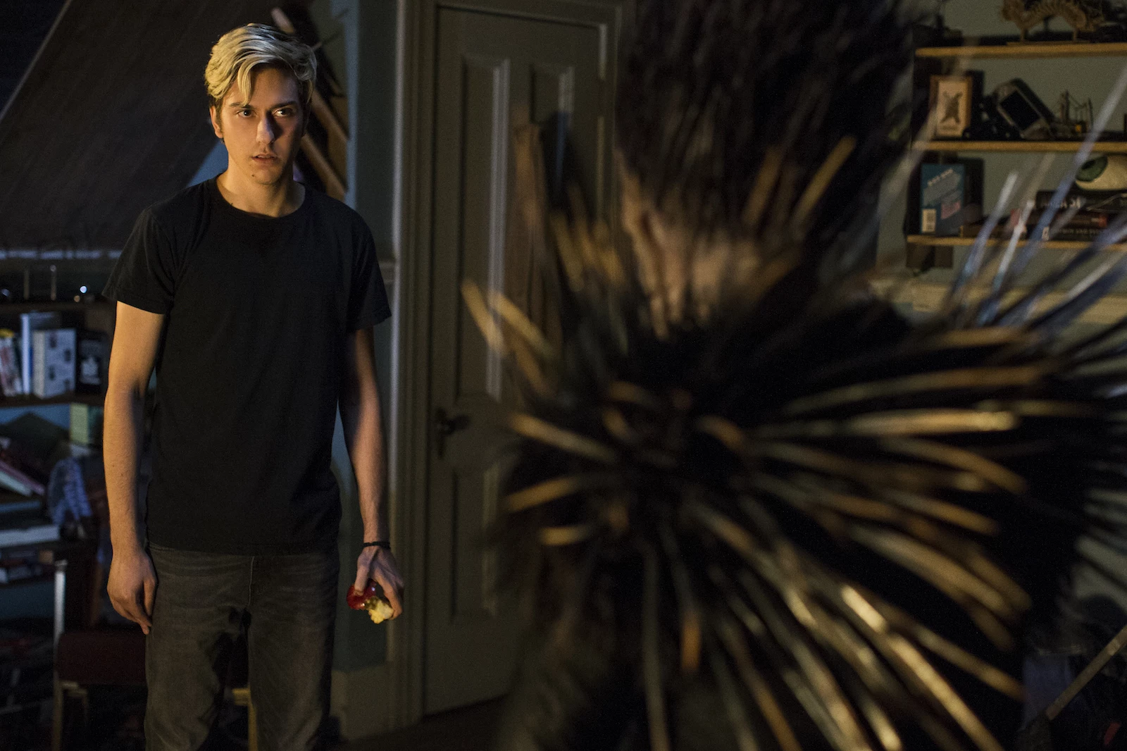 Nat Wolff as Light Turner stands looking at the monster Ryuk. Wingard, Adam. Death Note. Netflix Entertainment. 2017.