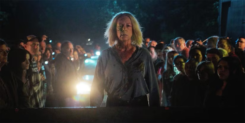 Laurie Strode, played by Jamie Lee Curtis, watches the destruction of Michael Myers  with the rest of Haddonfield. 