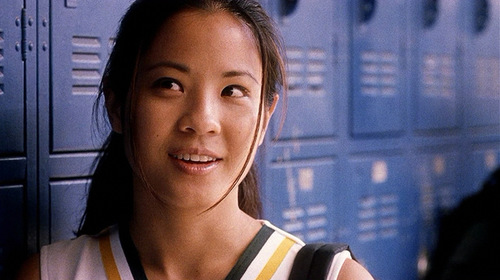 A close shot of Stephanie Vandergosh, portrayed by Karin Anna Cheung. She is smiling as she speaks to someone out of frame. 