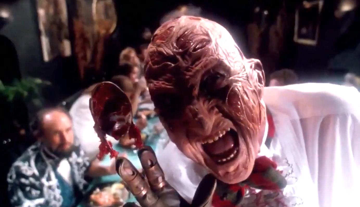 Robert Englund as Freddy Krueger. He's dressed as a chef, preparing to force-feed one of his victims.