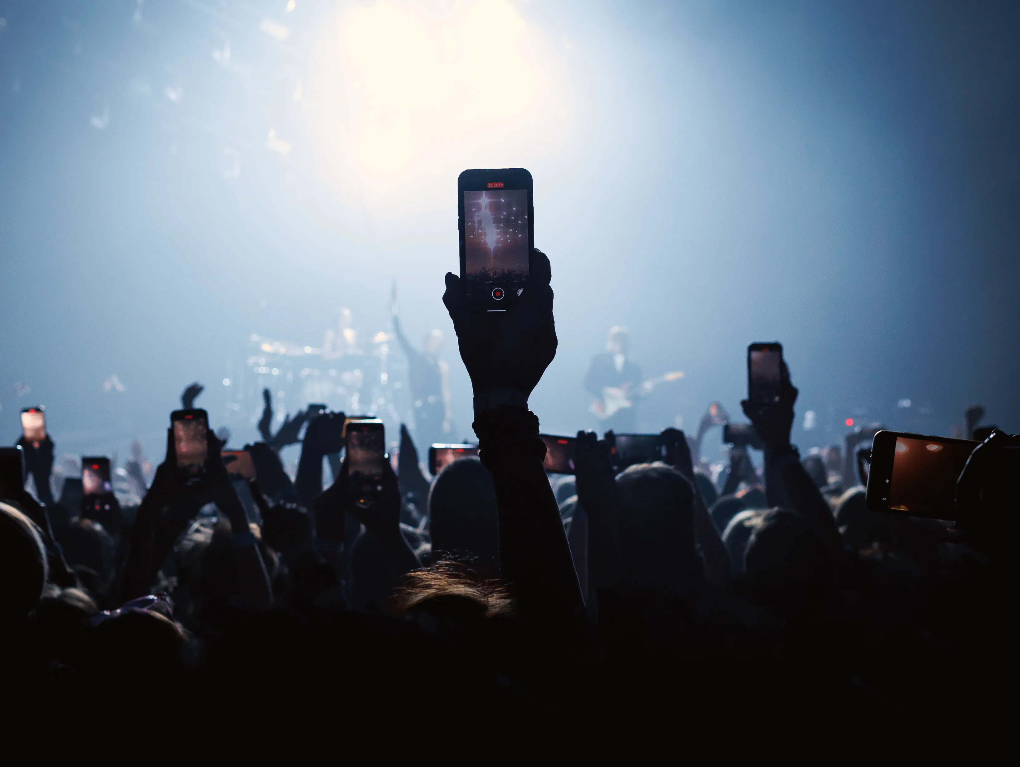 Concert audiences often recording for social media posting.