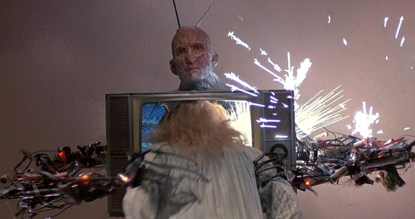 Freddy Krueger (Robert Englund) kills Jennifer (Penelope Sudrow), smashing her head into a TV set.