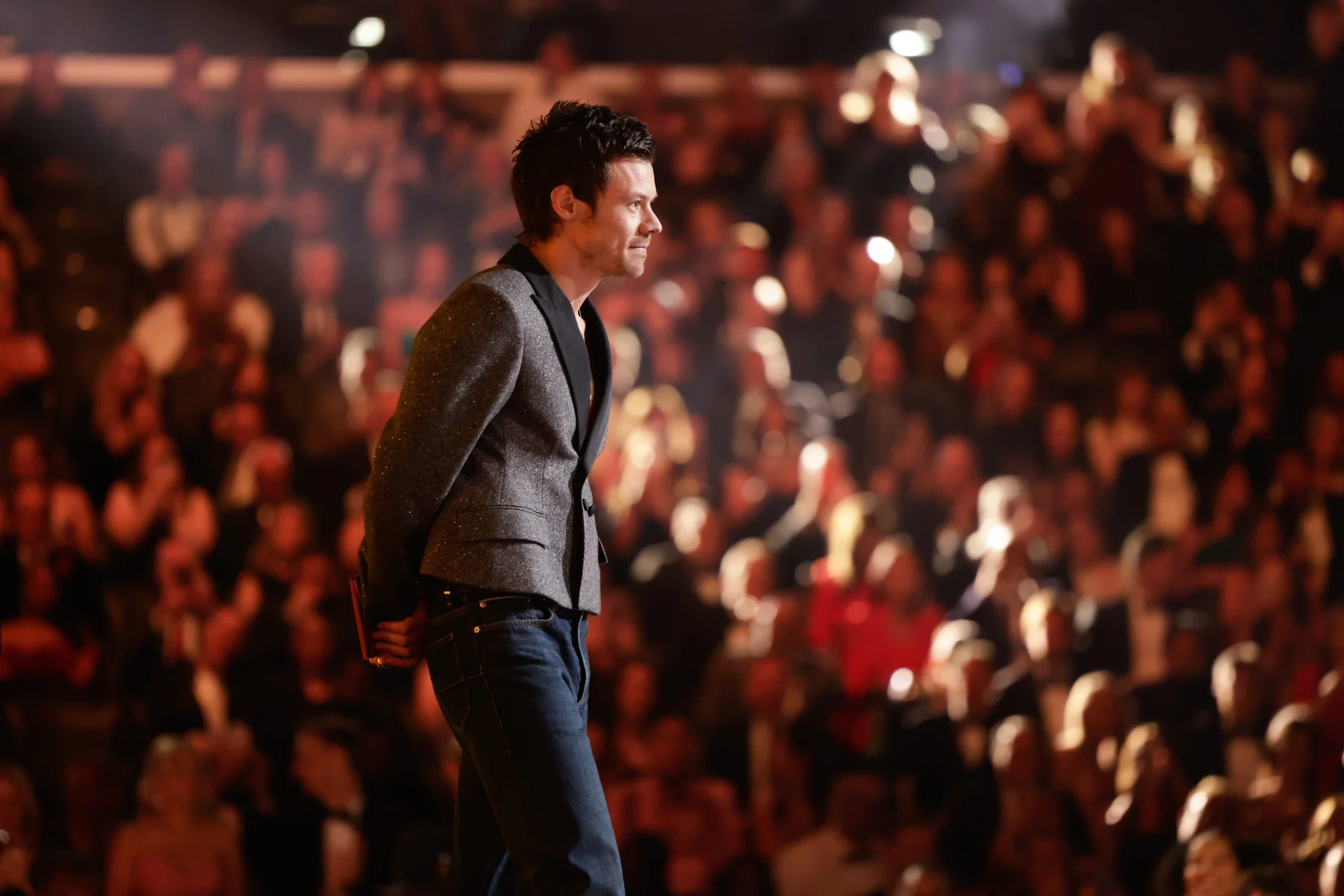 Harry Styles looking reflective at the end of his speech with the Grammys