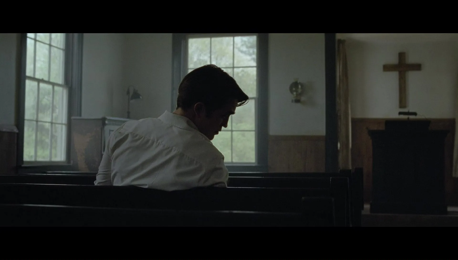 Reverend Teagardin being confronted by Arvin in the church. Campos, Antonio, Dir. The Devil All the Time. 2020.