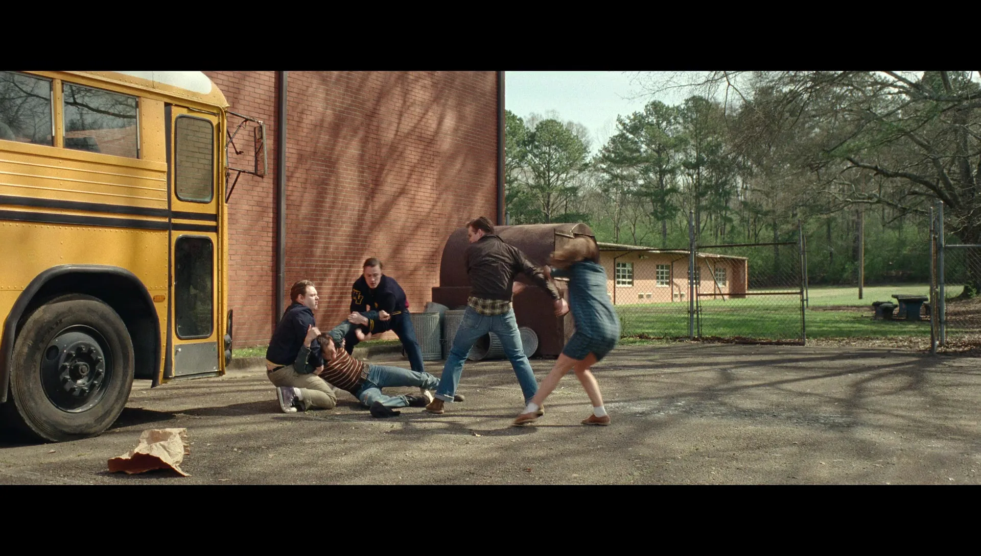 Arvin defending Leonora with tenacity from bullies outside the school. Campos, Antonio, Dir. The Devil All the Time. 2020.