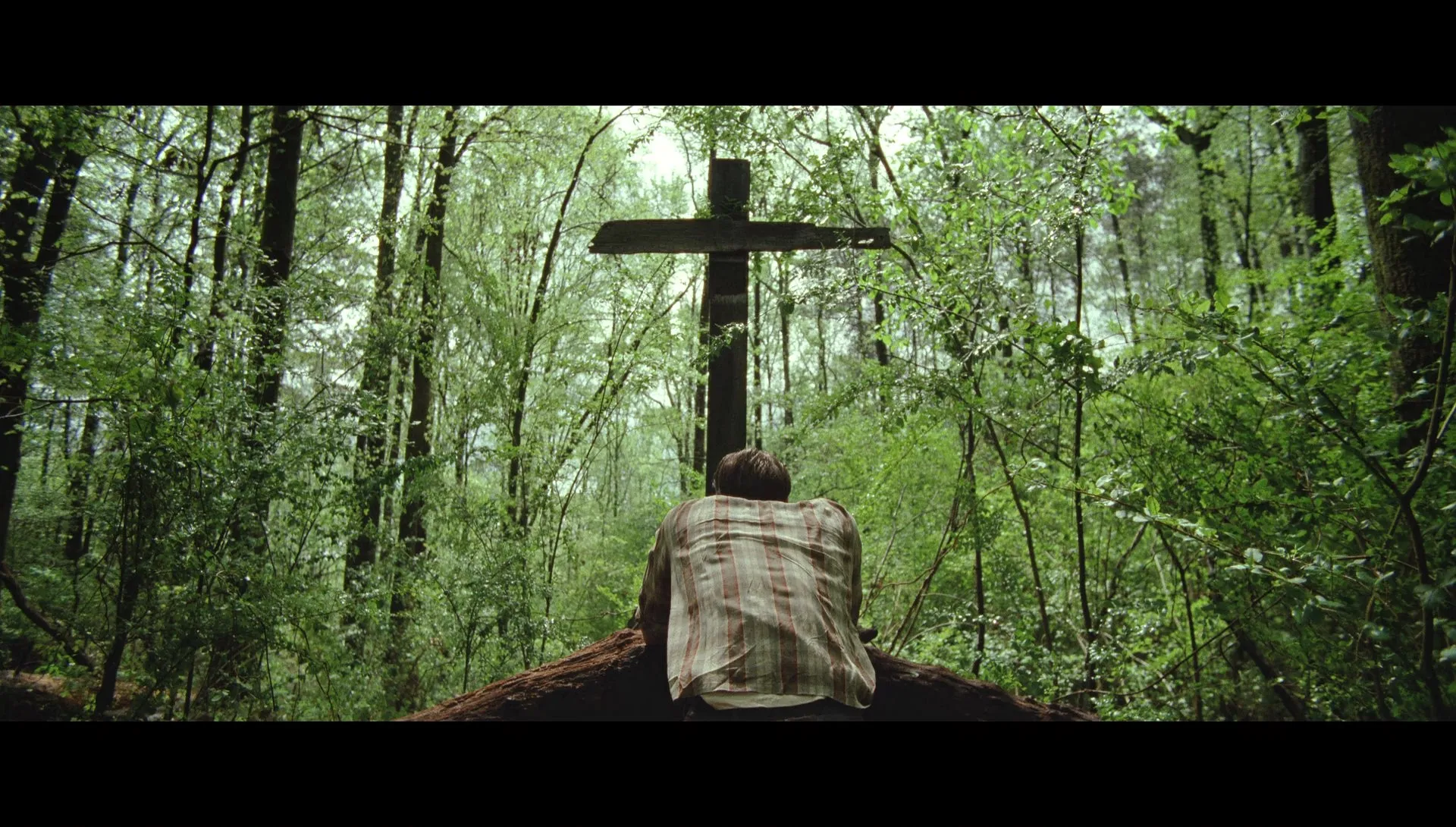 Williard Prays to the lord at his homemade altar.
