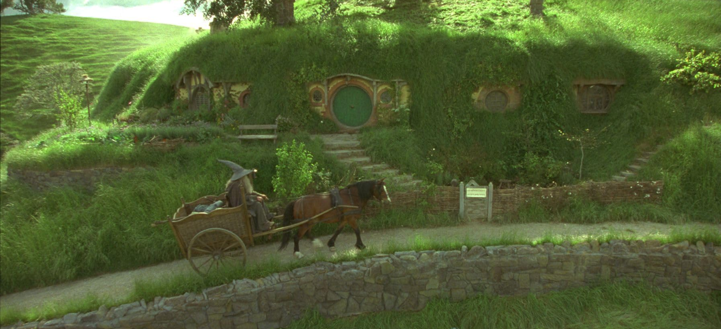 Gandalf driving a cart up to Bag End