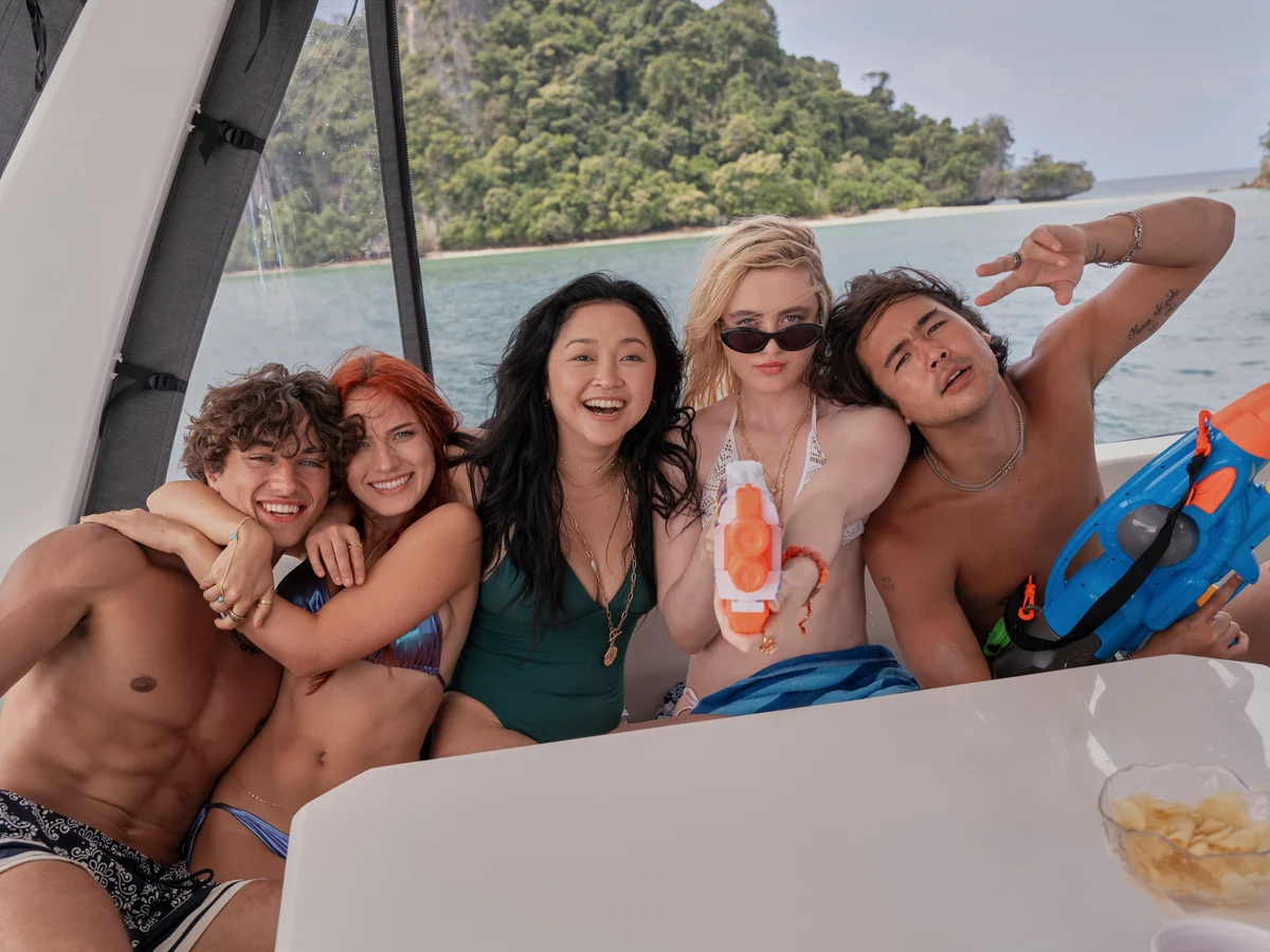 Friend group from The Devil's Mouth (Greg, Adrienne, Max, Sara, and James) sitting on the back of a yacht.