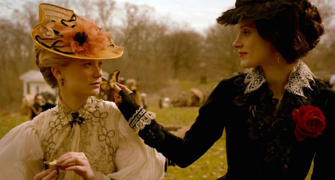 Edith and Lucille sit in the park. Edith is surrounded by butterflies, illustrating her innocent beauty, while Lucille is signified by moths, signifying her need to devour prey.