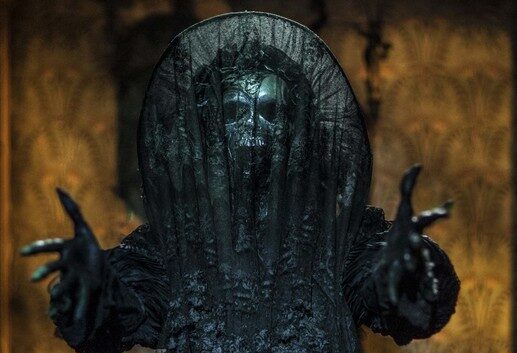 The ghost of Lucille and Thomas’s mother covered head to toe in gothic black mourning wear.