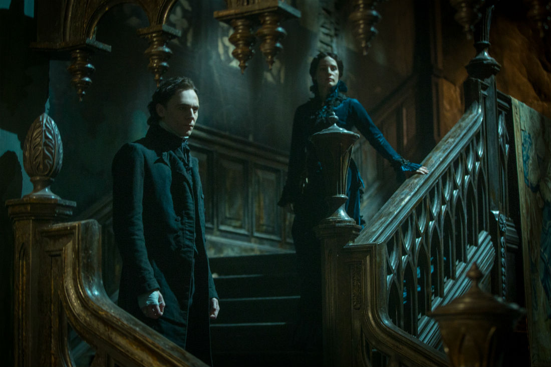 Lucille and Thomas on the stairs of Crimson Peak.