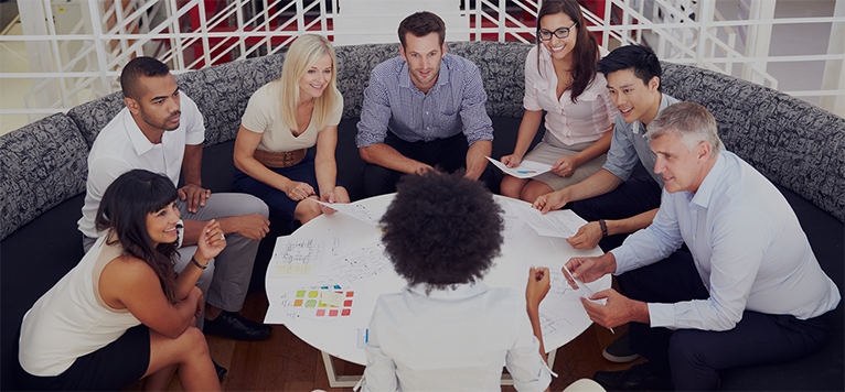 Diverse group meeting around tablev2