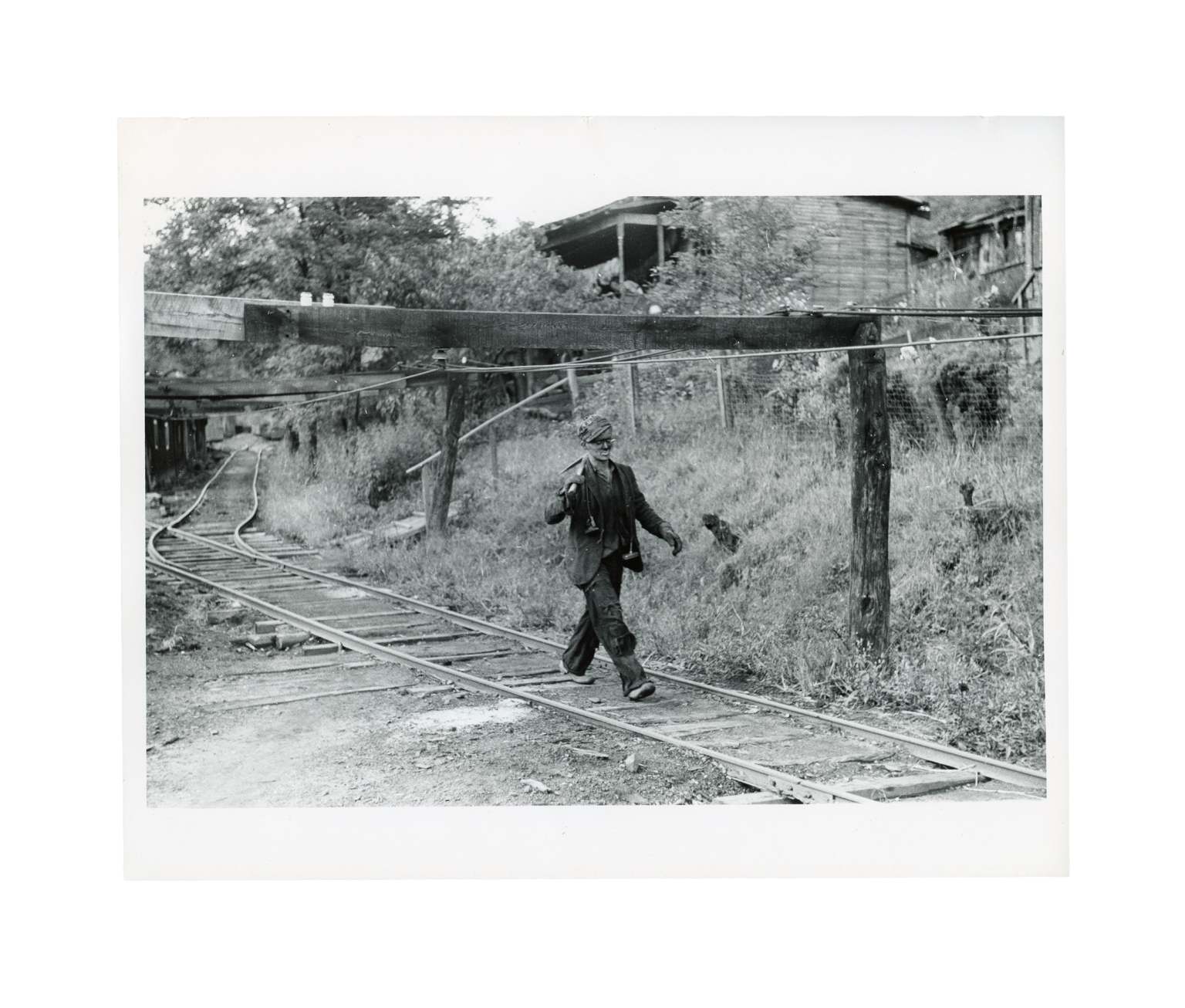 Coal miner returning from work with pick over shoulder. The "Patch," Chaplin, West Virginia, Wolcott, Marion Post,
