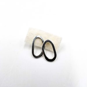 Two silver lopsided oval earrings