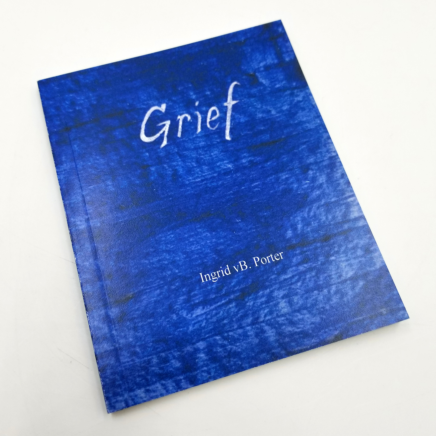 Blue book that says Grief on the cover