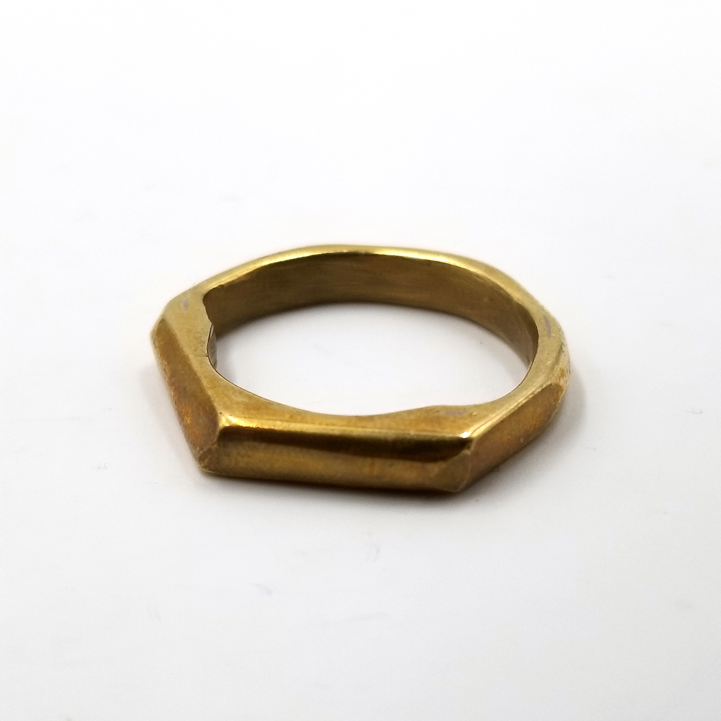 Spherical brass ring with angled edges