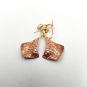 Two diamond shaped copper earrings with dented circles