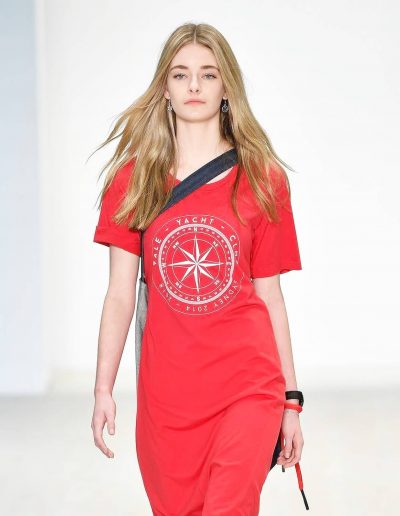 Model on a runway with soft wavy hairstyle and blonde highlights with a light bronde hair colour