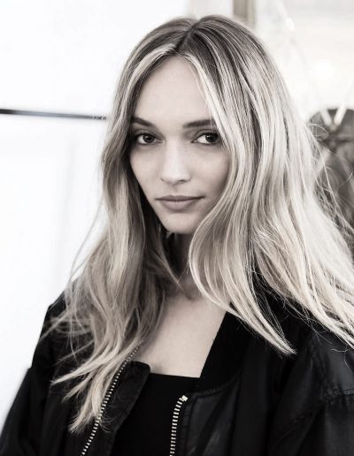 Fashion week Sydney Australia image of a girl with a center part hairstyle, long hair styled with soft waves and blonde balayage with face frame highlights