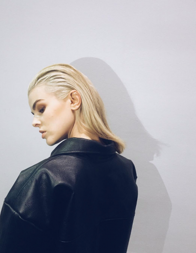 Grazia press model with a soft slick hairstyle and bleach blonde hair colour
