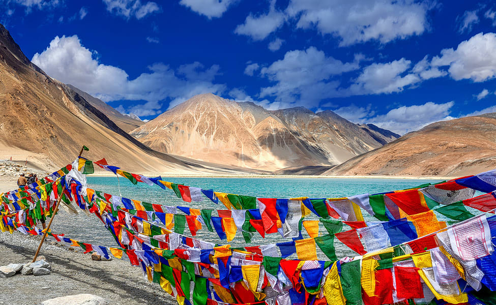 Tibetan Flags lined up amidst barren mountains. Ladakh. Travel. Backpack Trips. Solo Travelers. Ladakh is different from the rest of the world.