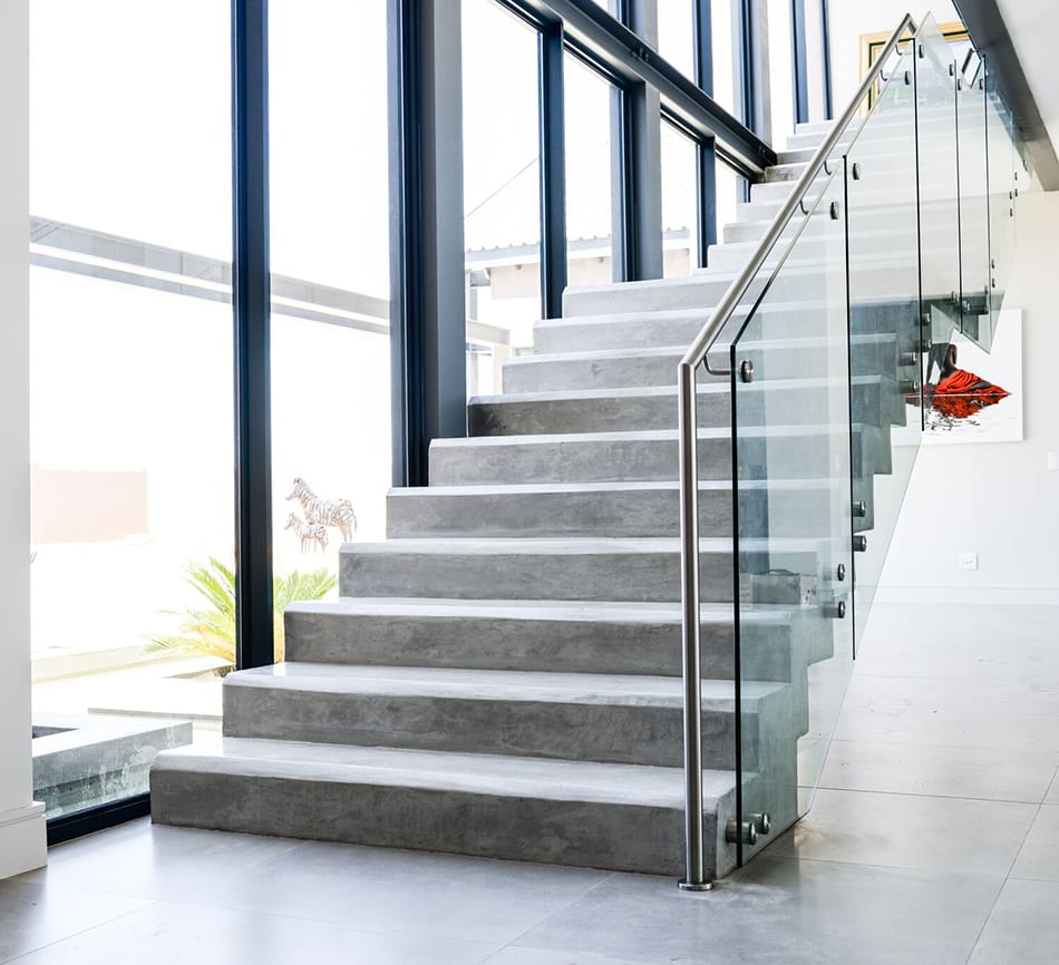 steel studio frameless glass balustrading on a modern concrete staircase 