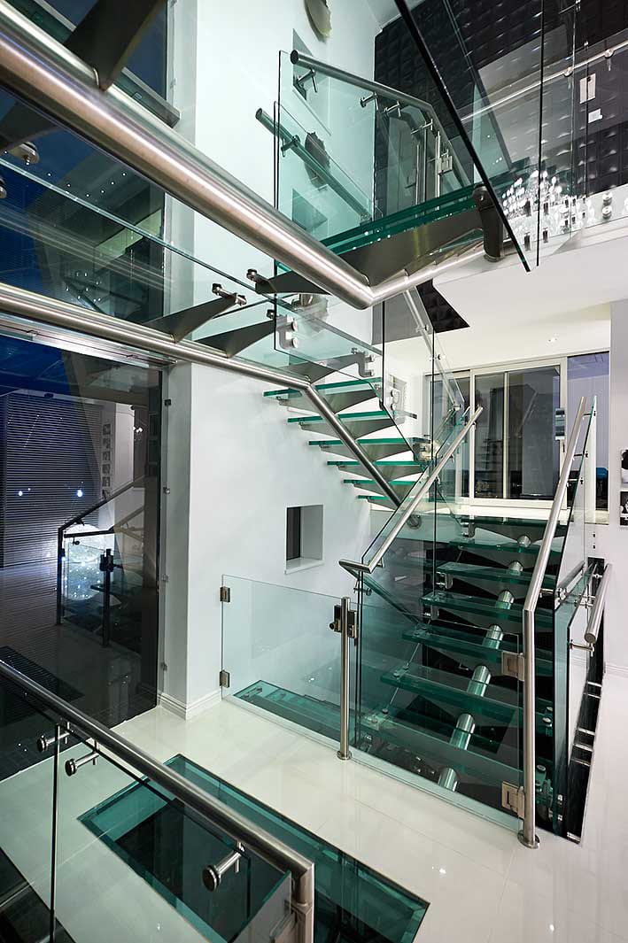 stainless steel staircase with glass treads and balustrades