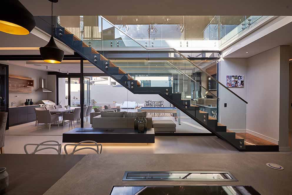 custom steel staircase with glass balustrades in modern living space