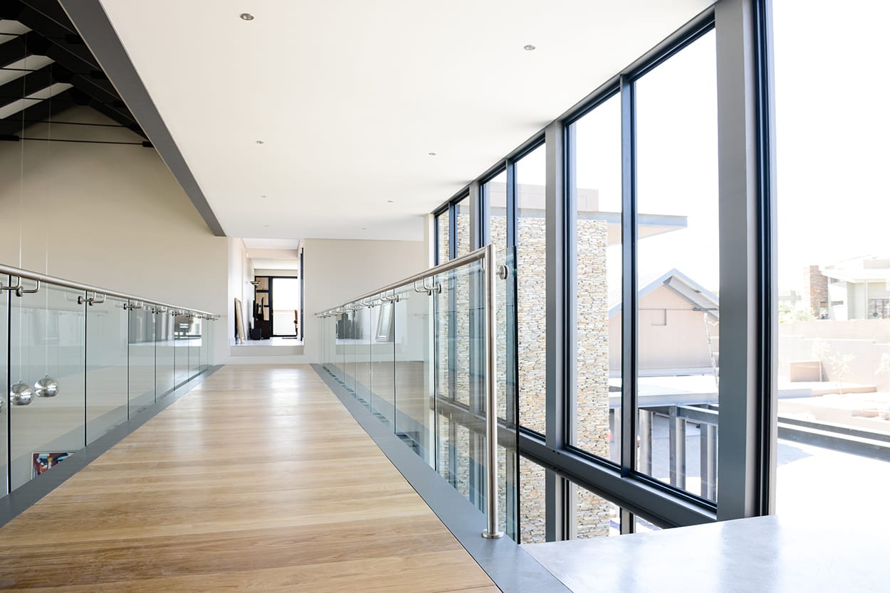 Steel studio frameless glass balustrades on a walkway.