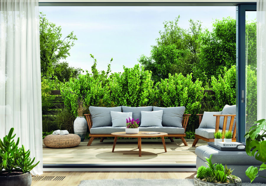 Cozy patio area with garden furniture, sliding doors and decking