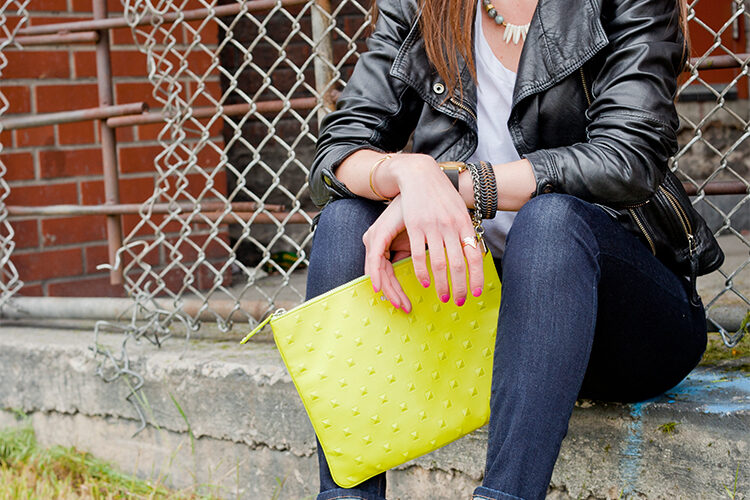 Style Bee in jeans, mixed material heels, a white tee and lime green clutch.