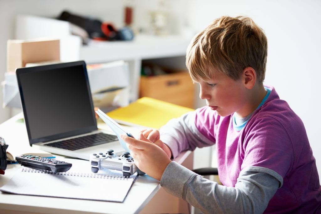 boy-playing-games-in-bedroom